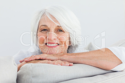 Woman leaning on a couch