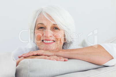 Woman leaning on a couch Woman leaning on a couch