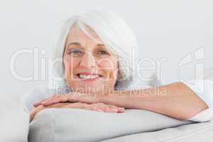 Woman leaning on a couch