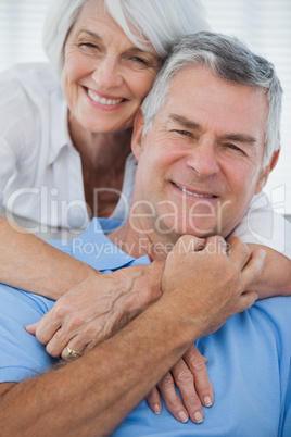 Portrait of woman embracing husband