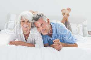 Beautiful couple lying on bed