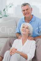 Man giving shoulder massage to wife