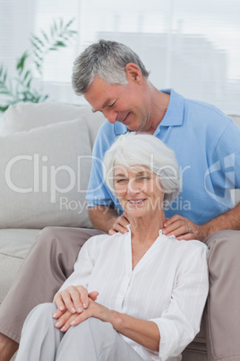 Man giving a shoulder massage to his wife