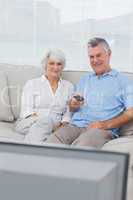 Couple watching television on the couch