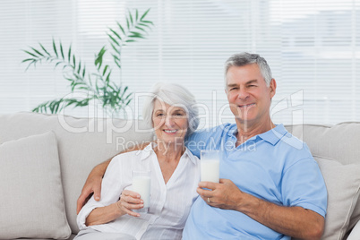 Couple drinking glasses of milk