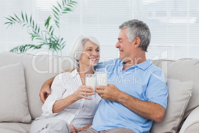 Couple clinking glasses of milk