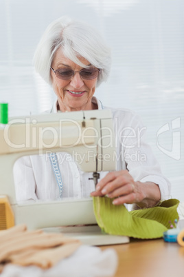 Woman using the sewing machine at home
