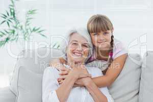 Little girl hugging her grandmother