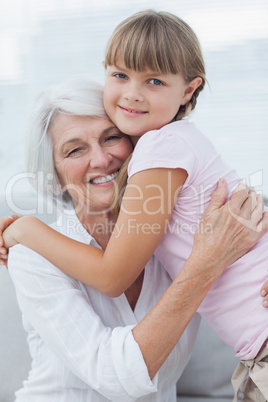 Cute girl hugging her grandmother