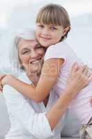 Cute girl hugging her grandmother