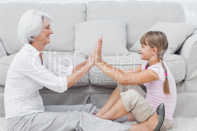 Little girl and grandmother playing together