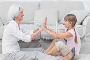Little girl and grandmother playing together