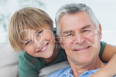 Portrait of grandson hugging grandfather