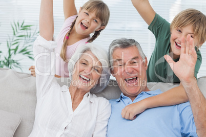 Grandchildren and grandparents raising their arms