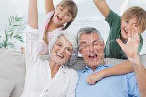 Grandchildren and grandparents raising their arms