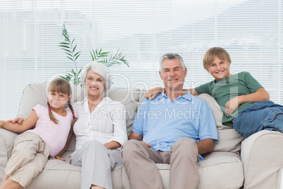 Grandparents and grandchildren sitting on couch