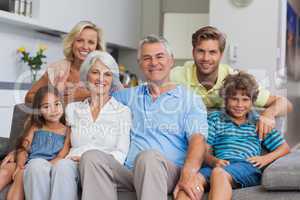 Multi-generation family posing in the living room