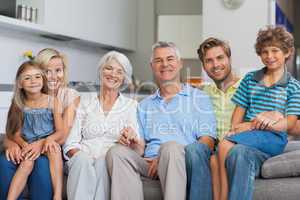 Extended family sitting on couch in living room