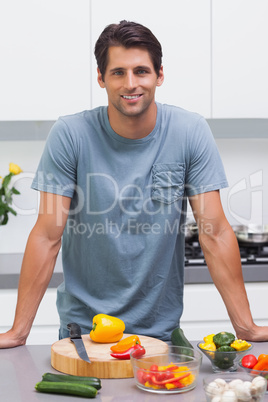 Attractive man standing in his kitchen