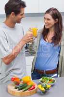Lovely couple clinking glass of orange juice