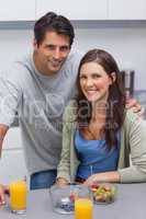 Smiling couple sitting in kitchen