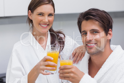 Couple holding glass of orange juice