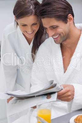 Lovely couple reading newspaper