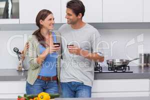 Couple clinking their glasses of red wine