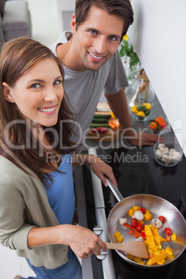 Couple cooking vegetables in the kitchen