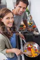 Couple cooking vegetables in the kitchen