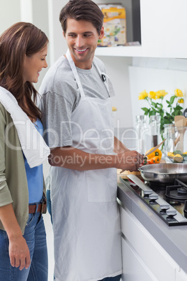 Man wearing apron and cooking