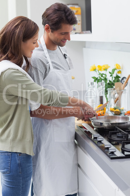 Delighted couple cooking