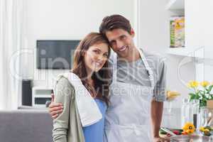 Lovely couple embracing in kitchen