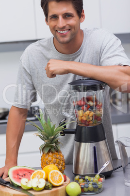 Attractive man leaning on his blender