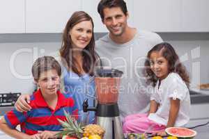 Family posing with a blender