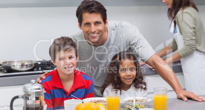 Father and his children smiling at camera