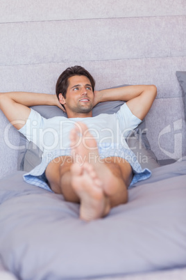 Man relaxing in his bed
