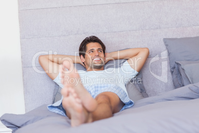 Smiling man resting in bed