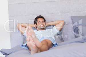 Smiling man resting in bed