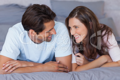 Man and woman lying on bed