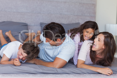 Parents tickling their children