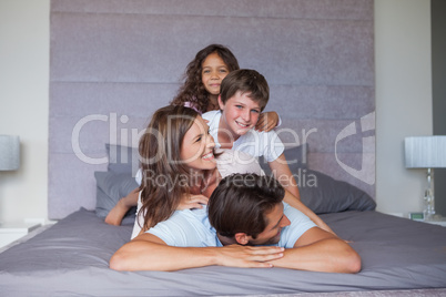 Family playing together in the bedroom