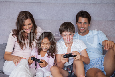 Smiling family playing video games