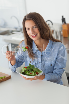 Attractive woman eating a salad