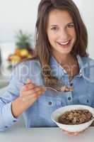 Pretty woman eating cereal