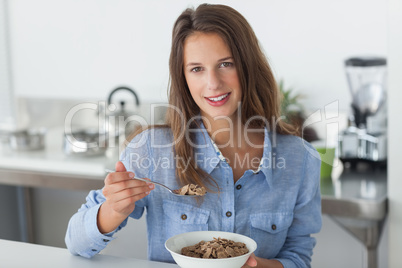 Attractive woman eating cereal