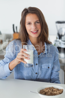 Attractive woman holding a glass of milk