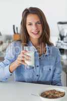 Attractive woman holding a glass of milk