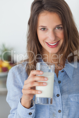 Pretty woman holding a glass of milk