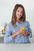 Pretty woman holding a glass of orange juice